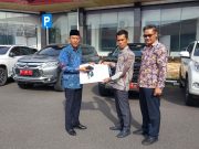 Dja’far Shodiq Serahkan Kendaraan Dinas dengan Kuncinya Kepada Kabag Perlengkapan Didampingi Kabag Umum Di Halaman Kantor Pemkab OKI
